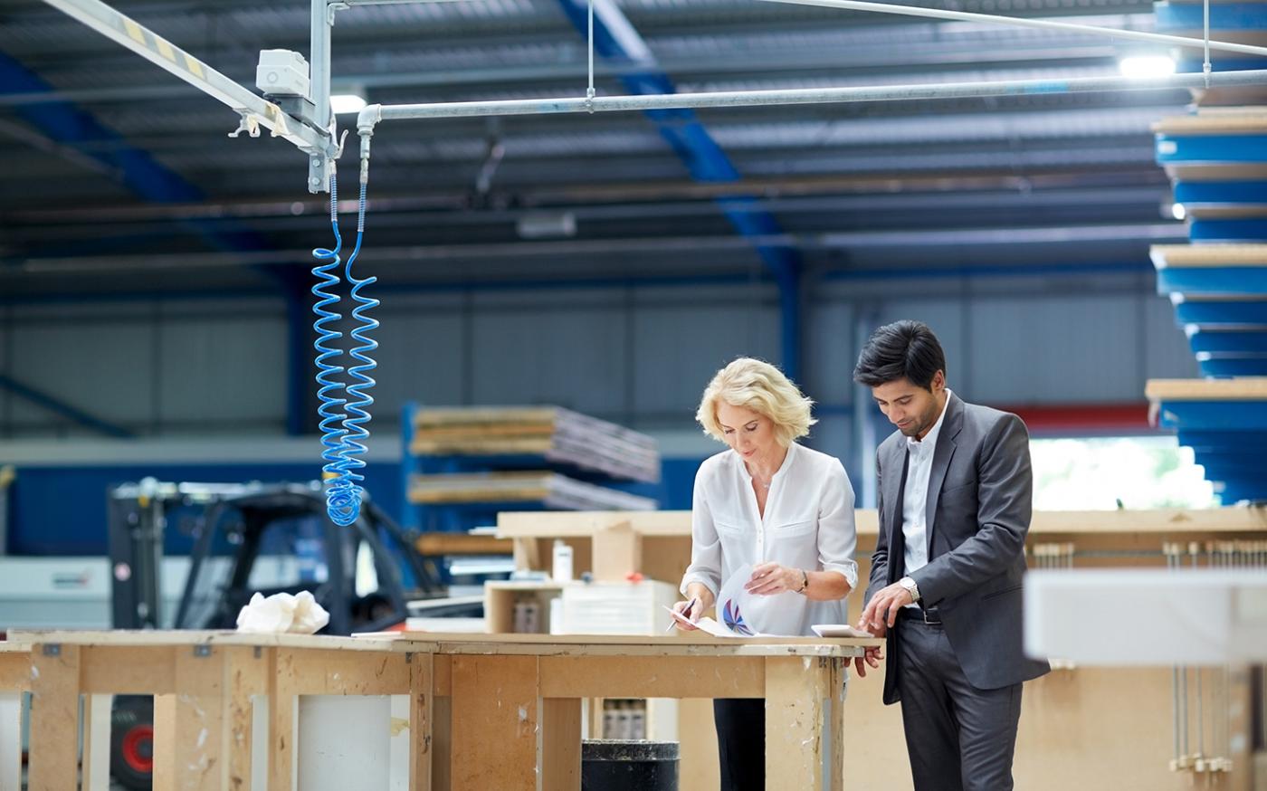 business-people-reviewing-documents-in-workshop-station